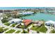 An aerial view showcases homes nestled along a canal with docks, offering stunning waterfront living and quick boat access at 320 Bath Club Blvd S, North Redington Beach, FL 33708