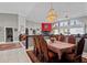 Dining room with a large table, chairs, chandelier, tile floors and arched windows in the home at 320 Bath Club Blvd S, North Redington Beach, FL 33708