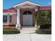 Elegant entrance with columns, stone steps, and manicured landscaping at 320 Bath Club Blvd S, North Redington Beach, FL 33708