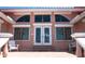 Exterior of home featuring arched windows and a double door entry at 320 Bath Club Blvd S, North Redington Beach, FL 33708