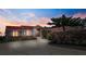 Inviting single-story home boasts a red tile roof, manicured landscaping, and a spacious driveway at 320 Bath Club Blvd S, North Redington Beach, FL 33708