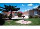 Charming home featuring a well-manicured lawn, fountain, and a covered front entrance with columns at 320 Bath Club Blvd S, North Redington Beach, FL 33708