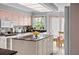 Charming kitchen with a center island and adjacent dining area offering a cozy atmosphere at 320 Bath Club Blvd S, North Redington Beach, FL 33708