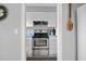 Practical kitchen area with white cabinets and stainless steel appliances, maximizing space at 320 Bath Club Blvd S, North Redington Beach, FL 33708