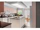 Well-lit kitchen featuring an island, light-colored cabinetry, and modern appliances for cooking and entertaining at 320 Bath Club Blvd S, North Redington Beach, FL 33708