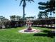 Decorative water fountain centered in lush lawn and landscaping at 320 Bath Club Blvd S, North Redington Beach, FL 33708