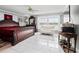 Serene main bedroom with ample natural light and white tile floors overlooking the water at 320 Bath Club Blvd S, North Redington Beach, FL 33708