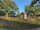 A colorful playground with slides, climbing structures, and a shaded gazebo, perfect for outdoor activities at 320 Bath Club Blvd S, North Redington Beach, FL 33708