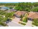 Aerial view of a single-Gathering home with a brick driveway, lush landscaping, and waterfront access at 3321 Mapleridge Dr, Lutz, FL 33558