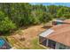 View of an expansive backyard with screened in lanai, pool, and fencing at 3321 Mapleridge Dr, Lutz, FL 33558