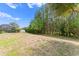 Large backyard with views of a lake and trees, enhanced by professional landscaping at 3321 Mapleridge Dr, Lutz, FL 33558