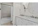Well-lit bathroom features a double vanity with marble countertop, oval mirrors, and a shower-tub combo at 3321 Mapleridge Dr, Lutz, FL 33558