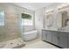 Bright bathroom features a freestanding tub, glass-enclosed shower, and double vanity sinks with ample counter space at 3321 Mapleridge Dr, Lutz, FL 33558