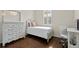 Charming bedroom features hardwood floors, a dresser with a mirror, and a desk near the window at 3321 Mapleridge Dr, Lutz, FL 33558