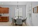 Charming dining area featuring a wooden table, seating for six, and natural light from nearby windows at 3321 Mapleridge Dr, Lutz, FL 33558