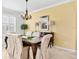 Tastefully decorated dining room with an elegant chandelier, comfortable seating, and plantation shuttered window at 3321 Mapleridge Dr, Lutz, FL 33558