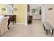 Inviting entryway with neutral tile floors, decorative bench, and arched doorway leading to the living area at 3321 Mapleridge Dr, Lutz, FL 33558