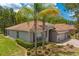 Beautiful single-story home with a lush lawn, landscaping, and a two-car garage at 3321 Mapleridge Dr, Lutz, FL 33558
