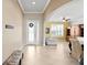 Elegant foyer leading to a brightly lit living area with neutral tile flooring and a decorative entryway at 3321 Mapleridge Dr, Lutz, FL 33558