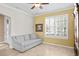 Bright living room featuring a neutral couch, plantation shutters, and elegant tile flooring in a cozy atmosphere at 3321 Mapleridge Dr, Lutz, FL 33558