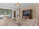Cozy living room with an oversized sectional, grandfather clock, and entertainment center with a large screen TV at 3321 Mapleridge Dr, Lutz, FL 33558