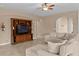 Comfortable living room featuring a large sectional sofa, entertainment center, and neutral color scheme at 3321 Mapleridge Dr, Lutz, FL 33558