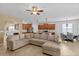 Bright and airy living room featuring a large sectional sofa connecting to the kitchen and dining area at 3321 Mapleridge Dr, Lutz, FL 33558