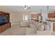 Open-concept living room with a large sectional sofa, connecting the living area to the kitchen with breakfast bar at 3321 Mapleridge Dr, Lutz, FL 33558
