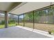The screened-in porch with a backyard view offers great outdoor living and entertaining space at 3321 Mapleridge Dr, Lutz, FL 33558