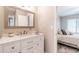 Bathroom with white cabinets and counters, modern faucet and sink, and decor at 3540 42Nd S St # F, St Petersburg, FL 33711