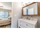Bathroom view with white vanity and sink adjacent to bedroom featuring neutral decor at 3540 42Nd S St # F, St Petersburg, FL 33711