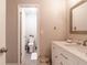 Stylish bathroom with a modern white vanity, framed mirror, and a view to the commode at 3540 42Nd S St # F, St Petersburg, FL 33711