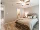 Bedroom with ceiling fan, light-colored walls and flooring, wood bed frame, and view to the bathroom at 3540 42Nd S St # F, St Petersburg, FL 33711