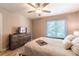 Cozy bedroom with a ceiling fan, dresser and natural light from the window at 3540 42Nd S St # F, St Petersburg, FL 33711