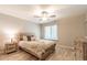 Bedroom with hardwood floors, neutral walls, a ceiling fan, and large window at 3540 42Nd S St # F, St Petersburg, FL 33711