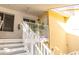Exterior view of a yellow and white condominium building with stairs leading to a patio at 3540 42Nd S St # F, St Petersburg, FL 33711