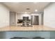 Bright kitchen boasts stainless steel appliances and granite countertops with a breakfast bar at 3540 42Nd S St # F, St Petersburg, FL 33711