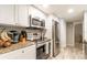 Kitchen features stainless steel appliances, granite countertops and white cabinets at 3540 42Nd S St # F, St Petersburg, FL 33711
