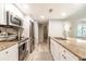 Kitchen area boasts stainless steel appliances, granite countertops, and tile floors at 3540 42Nd S St # F, St Petersburg, FL 33711