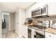 Kitchen space includes stainless steel appliances and granite countertops at 3540 42Nd S St # F, St Petersburg, FL 33711