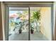 Private patio area with lush greenery and a tranquil view, accessible through sliding glass doors at 3540 42Nd S St # F, St Petersburg, FL 33711