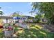 Landscaped backyard features raised garden beds and mature trees at 3614 S Lois Ave, Tampa, FL 33629