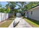 Backyard with storage shed, privacy fence, and mature trees at 3614 S Lois Ave, Tampa, FL 33629