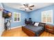 Bedroom features natural light, a ceiling fan, and wood flooring at 3614 S Lois Ave, Tampa, FL 33629