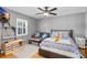 Cozy bedroom features a ceiling fan, natural light, and comfortable furniture at 3614 S Lois Ave, Tampa, FL 33629