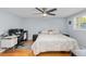 Bright bedroom featuring hardwood floors, ceiling fan, and a dedicated workspace at 3614 S Lois Ave, Tampa, FL 33629