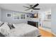 Primary bedroom with en-suite bathroom showcasing hardwood floors and great natural light at 3614 S Lois Ave, Tampa, FL 33629