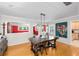 Bright dining room featuring stylish light fixture, modern art, and bamboo floors at 3614 S Lois Ave, Tampa, FL 33629