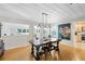Dining room features modern lighting, a large table, and an open view to other spaces at 3614 S Lois Ave, Tampa, FL 33629