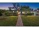 Charming single-story home with a brick pathway, lush lawn, and manicured hedges for enhanced curb appeal at 3614 S Lois Ave, Tampa, FL 33629